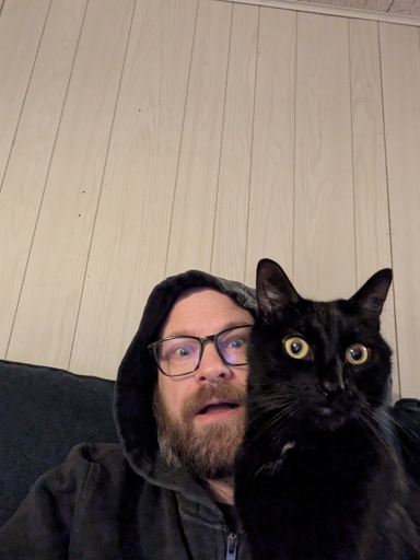 black cat on handsome young man's lap 